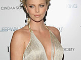 Charlize Theron showing off her sexy cleavage posing in a sexy dress