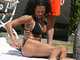 Melanie Brown shows her super body tanning in a tiny black bikini