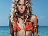 Pop singer Shakira looks hot posing in a tiny bikinis in the sea