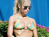 Jessica Simpson shows her huge tits tanning in a tiny bikini