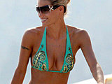 Michelle Hunziker caught showing off soft buns in a thong bikinis