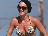 Pink posing all nude and sunbathing in bikini