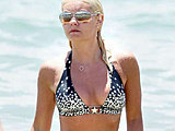 Elisha Cuthbert shows her sexy body in a wet bikini on the beach