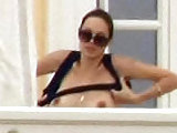 Angelina Jolie topless outside of her house