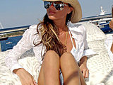 Victoria Beckham posing in bikini under white shirt on the yacht
