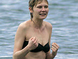 Kirsten Dunst looking tasty bathing in a wet black bikini and shirt