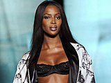 Naomi Campbell modelling in black bra showing hot long legs on podium