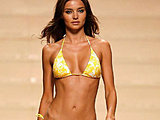 Young supermodel Miranda Kerr modelling teeniest bikinis on a runway