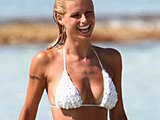 Michelle Hunziker caught revealing her booty cheeks in a tiny bikini