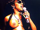 Lil' Kim flaunts her huge tits in exotic costumes