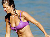 Helena Christensen caught in a tiny wet bikini on the beach candids