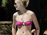 Kirsten Dunst shows her sexy body sunbathing in a teeny bikini