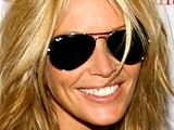 Elle Macpherson topless on a beach