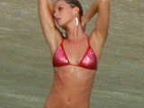 Gisele Bundchen showing her very sexy body in a teeny red bikini