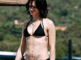 Asia Argento showing her ass and body in a sexy bikini on the beach