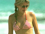 Cat Deeley caught sunbathing in a striped tiny bikini on the beach