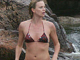 Charlize Theron gets so wet in her bikini near a waterfall candids