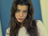 Young Liv Tyler flaunting sexy legs and springy belly in skirt and top