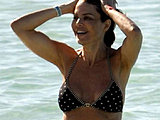 Lisa Rinna caught bathing in a tiny bikini on the beach candids