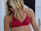 Kelly Ripa flaunting her tight body in a tiny bikini poolside