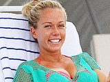 Kendra Wilkinson covering bikini body in fishnet